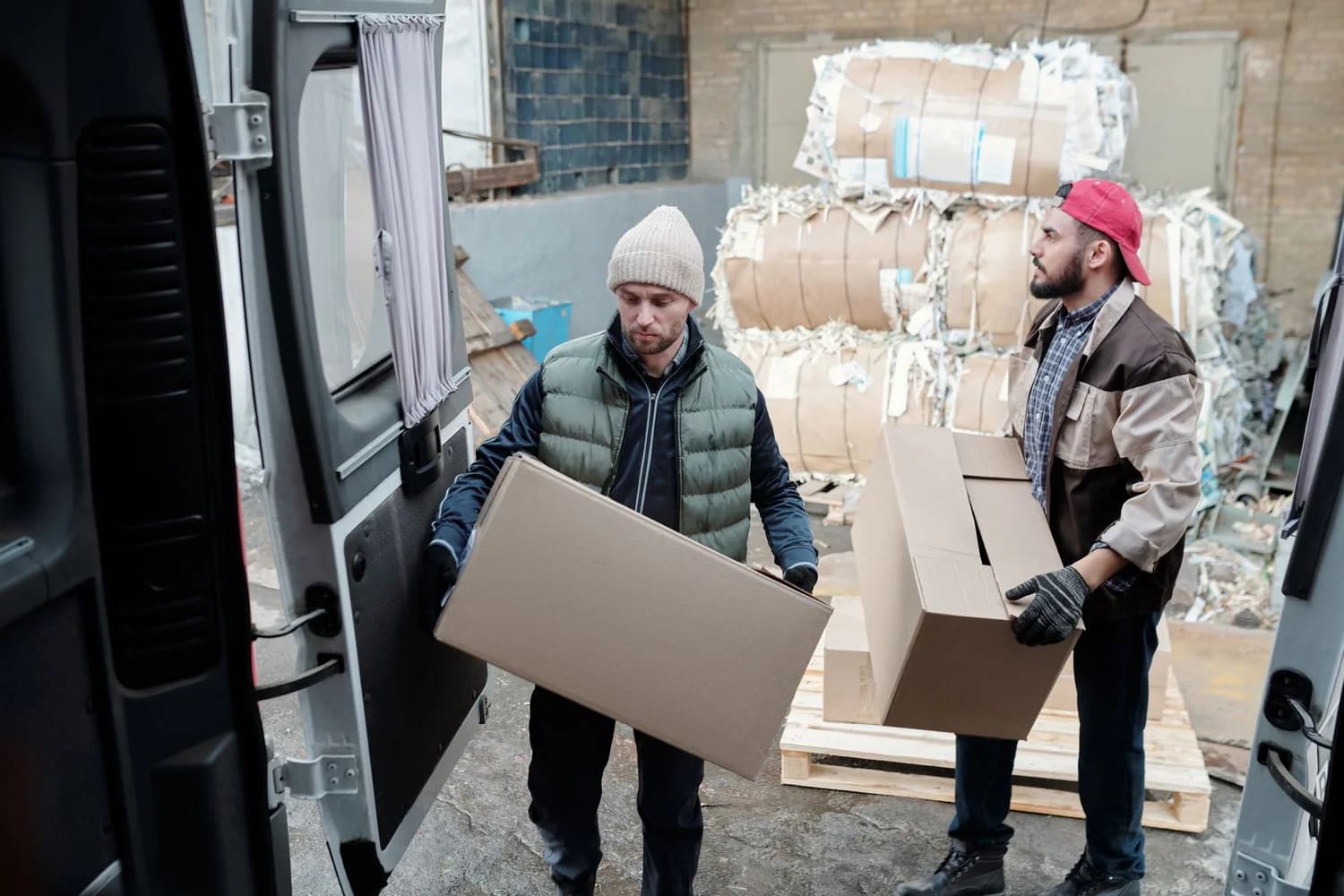Warehouse worker packing bundled product boxes for Amazon fulfillment