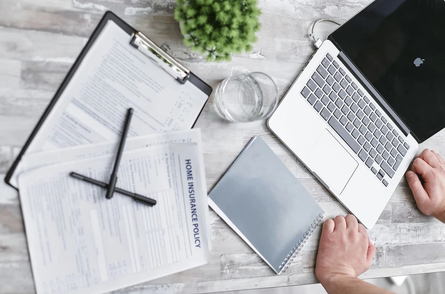 Amazon seller reviewing insurance policy documents at a desk