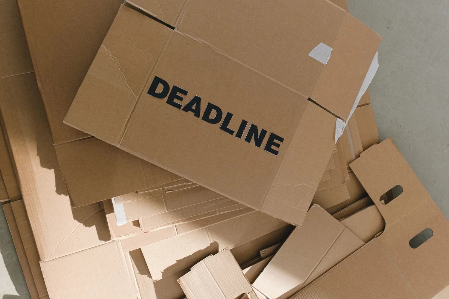 Warehouse worker stacking shipping boxes during peak holiday season