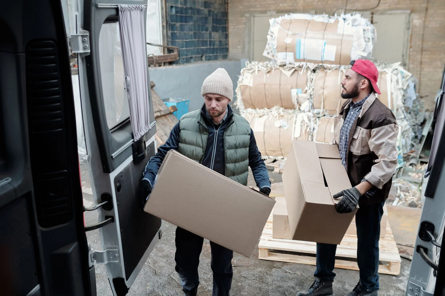 Warehouse worker packing bundled product boxes for Amazon fulfillment