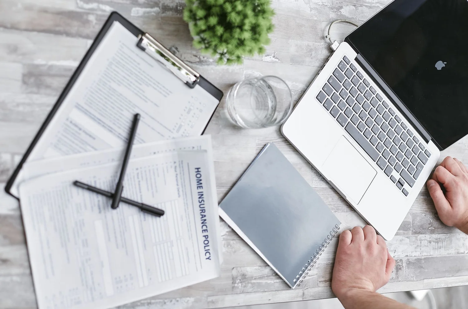 Amazon seller reviewing insurance policy documents at a desk
