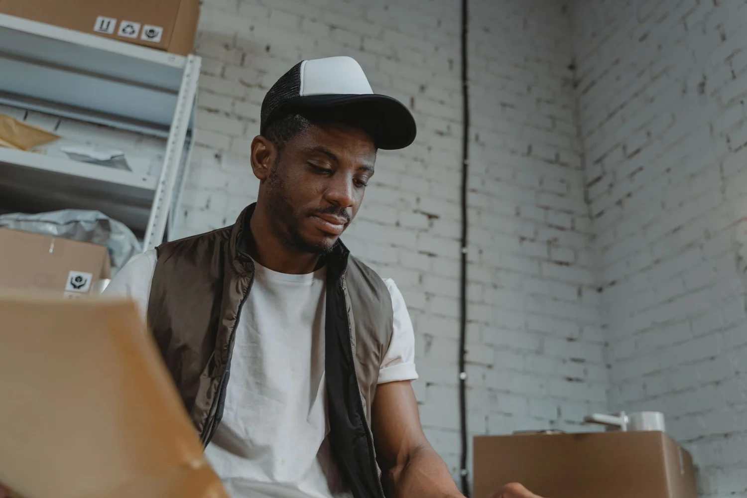 Warehouse worker checking parcel sizes before shipping Prime orders